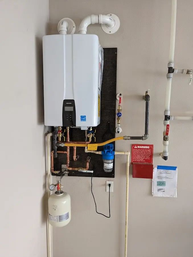 Professional plumber installing copper piping in a Ardsley home